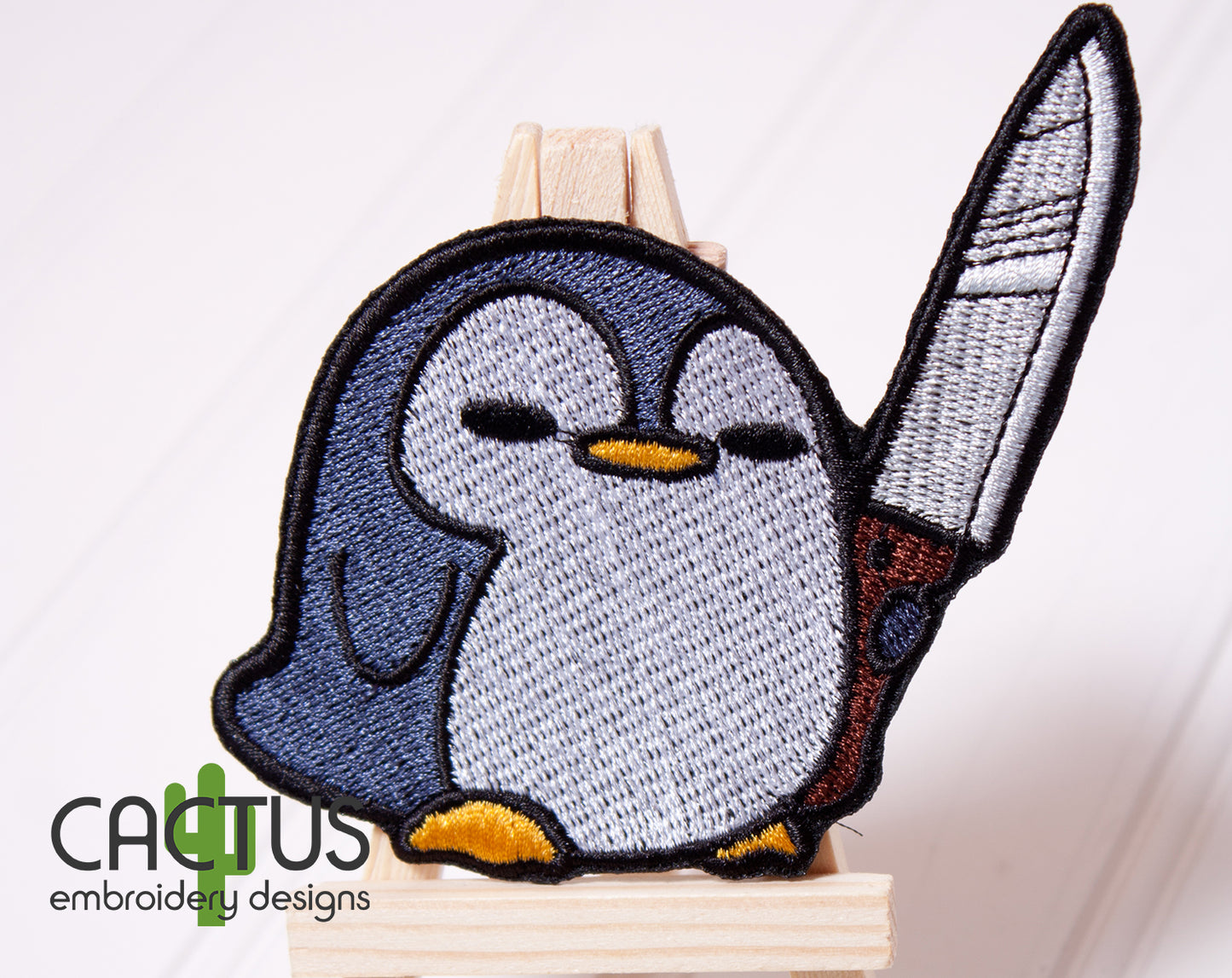 Penguin with a Knife Patch Embroidery Design