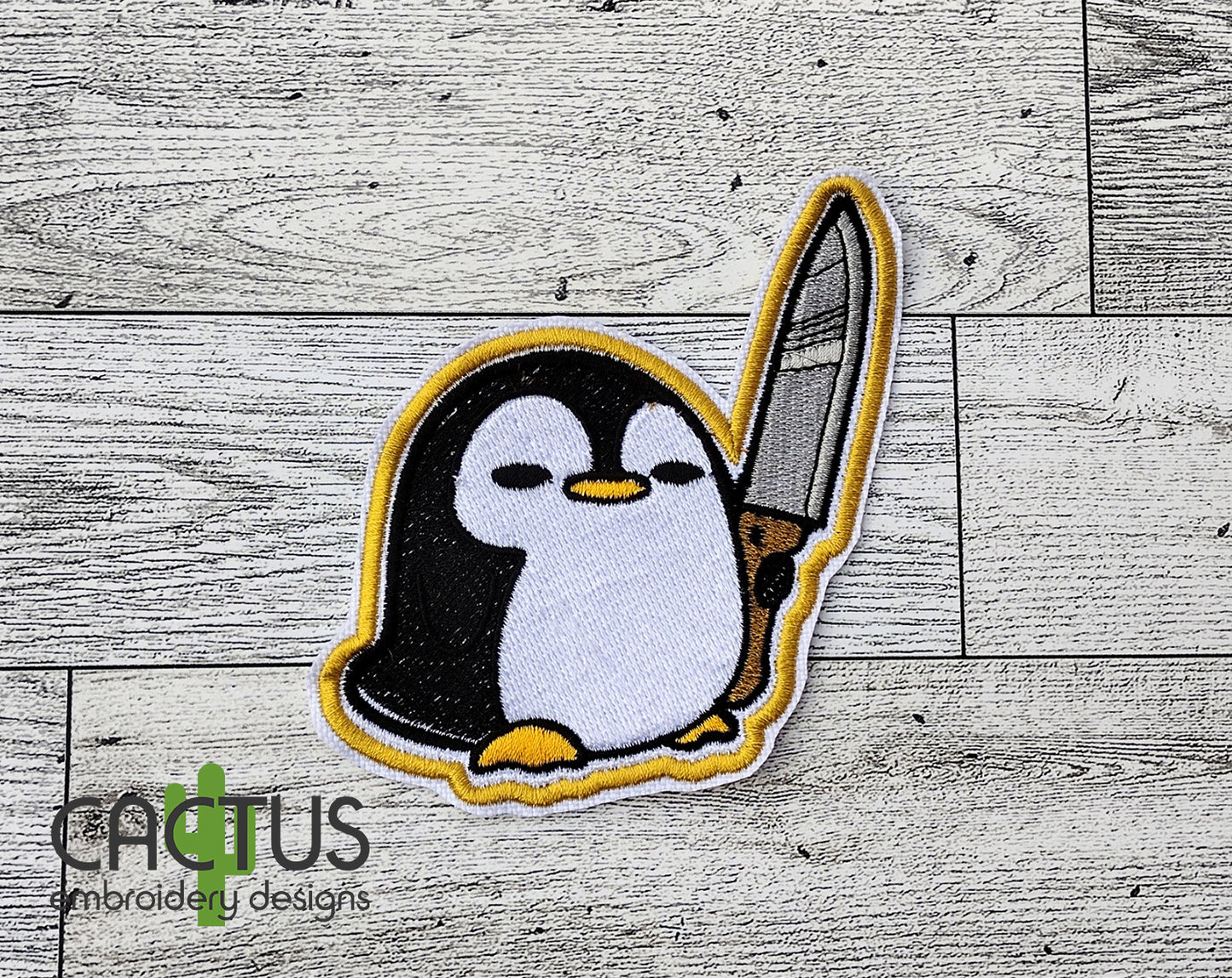 Penguin with a Knife Patch Embroidery Design