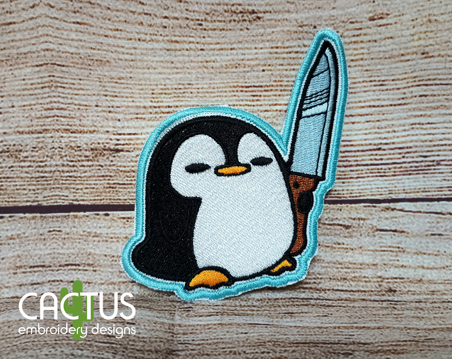 Penguin with a Knife Patch Embroidery Design