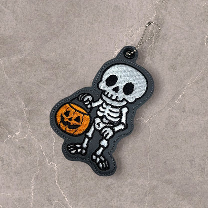 Skeleton with a Halloween Bucket Snap Tab & Eyelet Fob