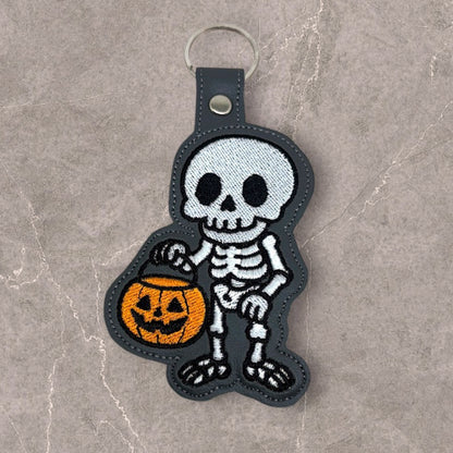 Skeleton with a Halloween Bucket Snap Tab & Eyelet Fob