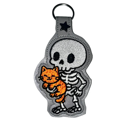Skeleton with a Kitty Snap Tab & Eyelet Fob