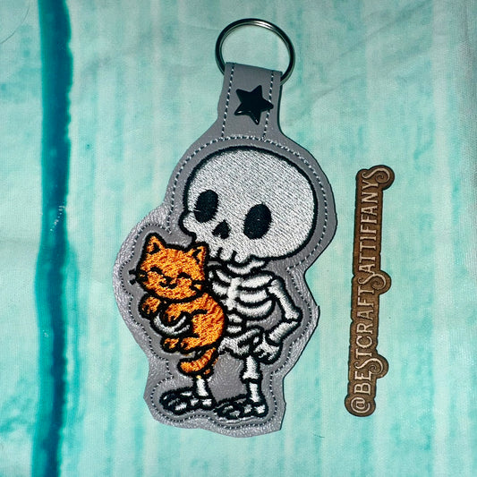 Skeleton with a Kitty Snap Tab & Eyelet Fob